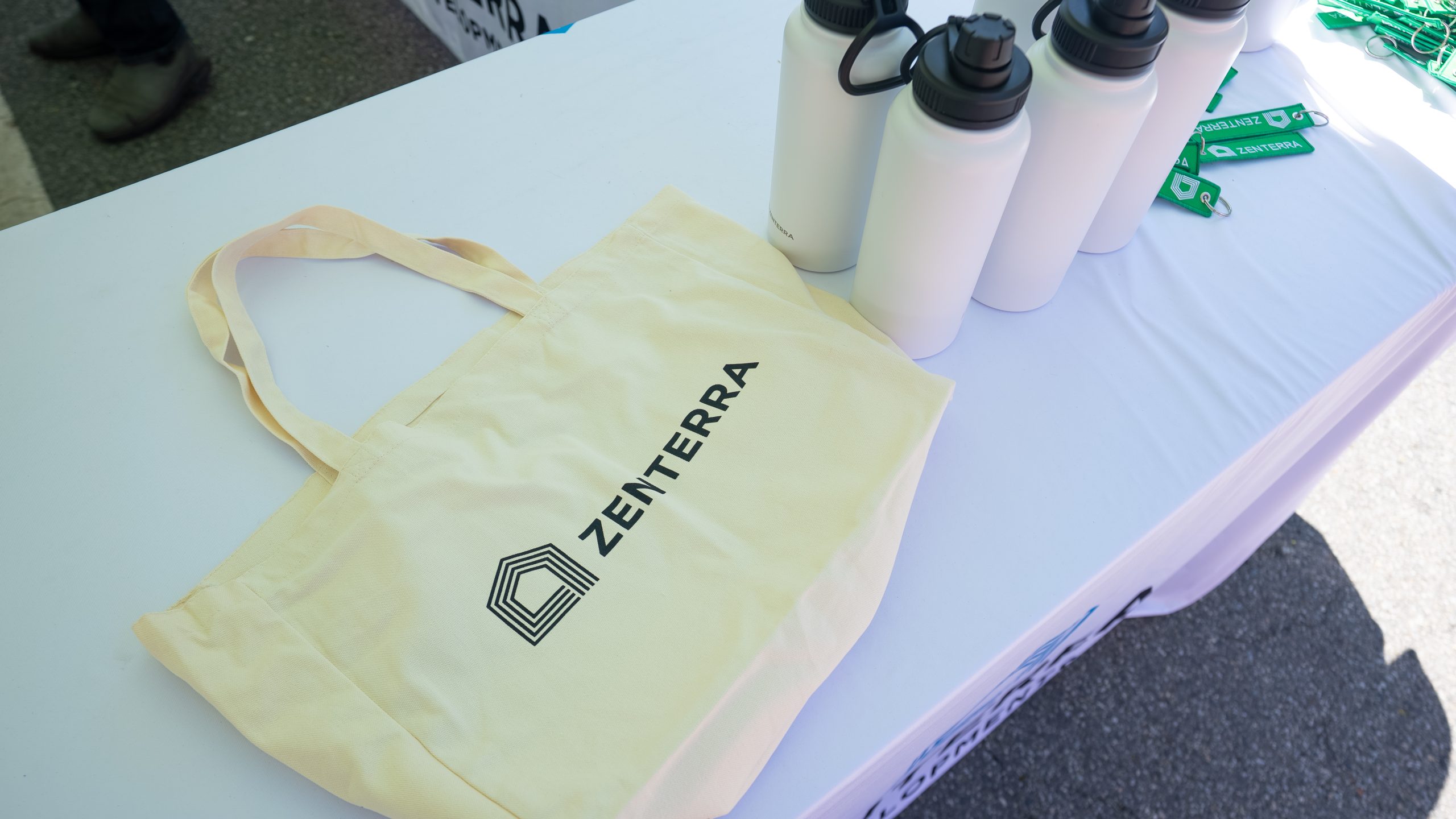 Zenterra Developments branded reusable canvas tote bag and water bottles on display