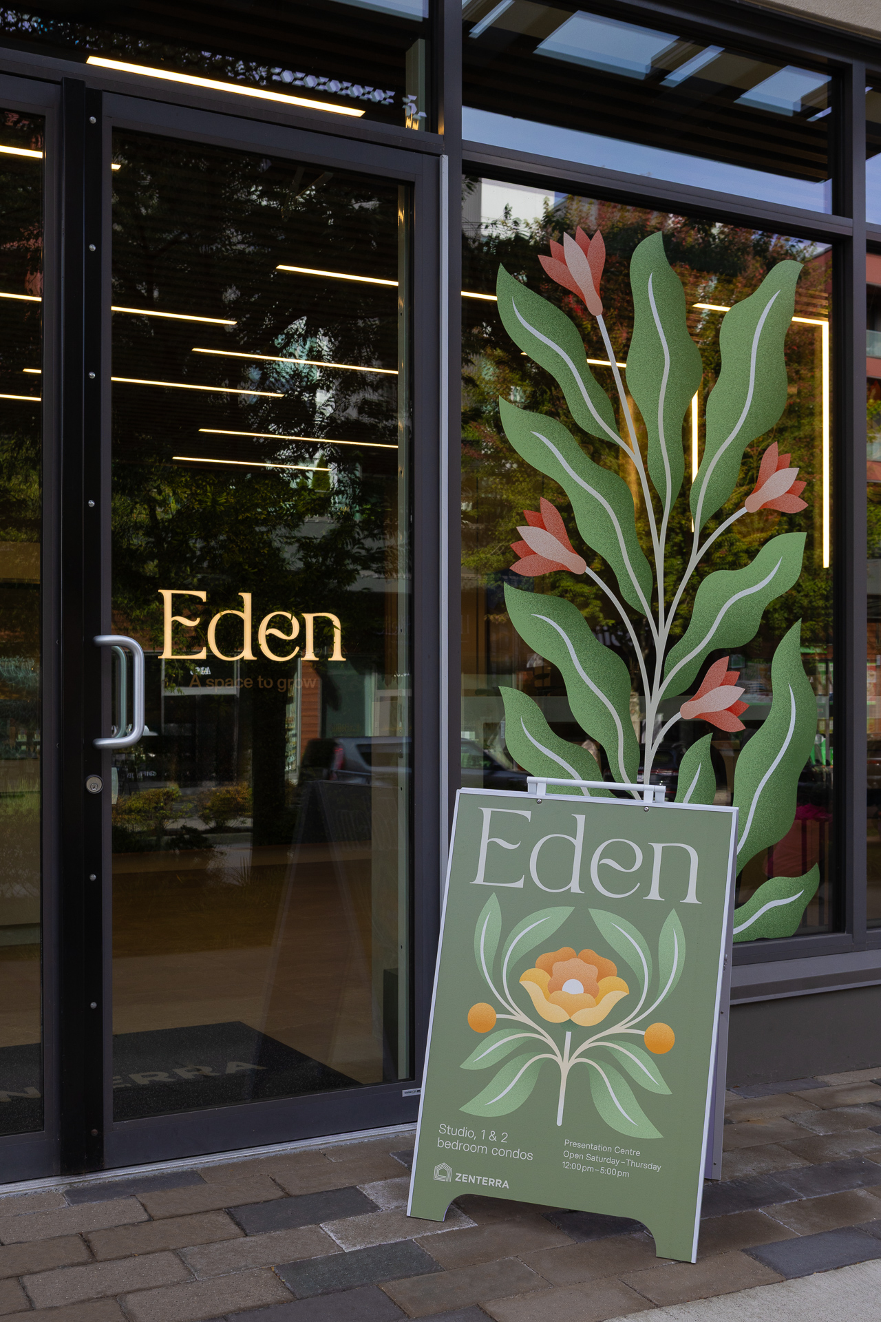 Eden presentation centre entrance door with gold vinyl lettering and custom A frame sandwich board