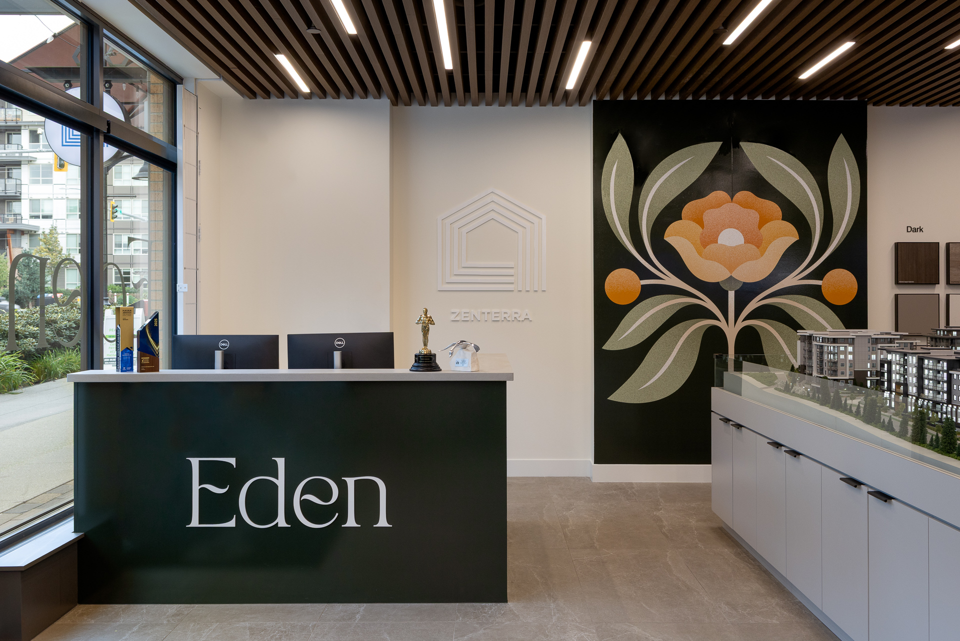 Eden presentation centre reception desk featuring Zenterra branding and custom floral wall mural