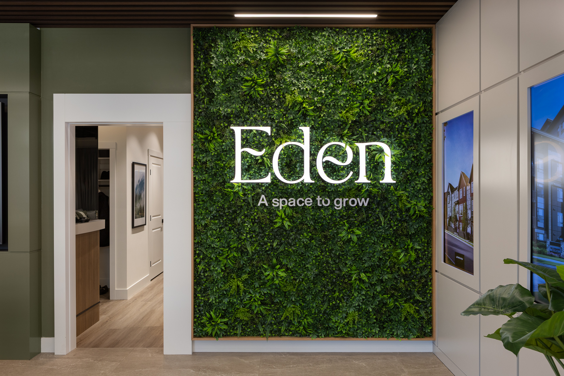 Eden logo and marketing tagline on artificial green moss feature wall inside presentation centre