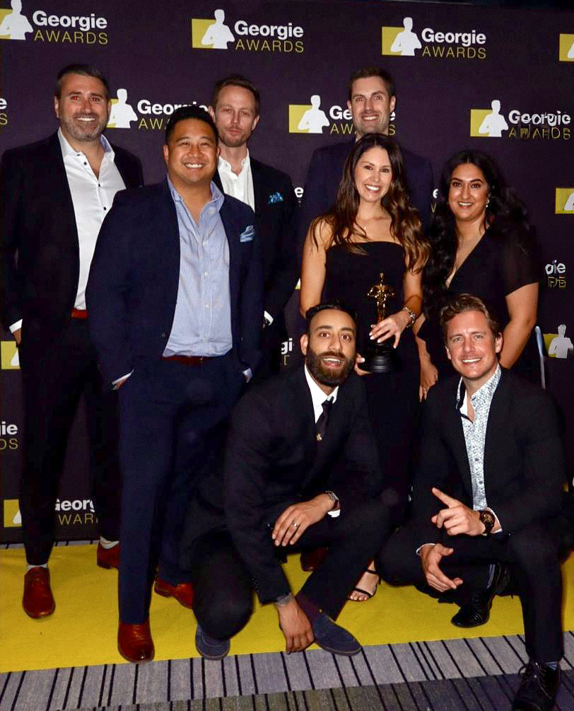 Zenterra Developments team group photo celebrating their wins at the Georgie Awards media wall