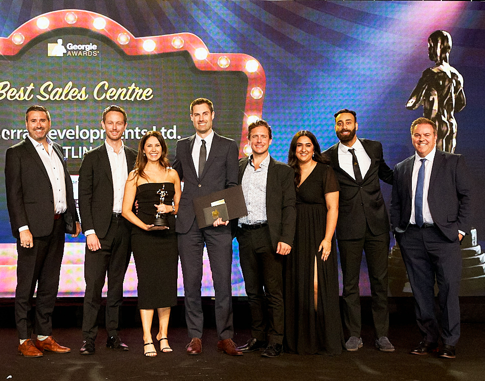 Zenterra Developments team accepting the Best Sales Centre trophy on stage at the Georgie Awards
